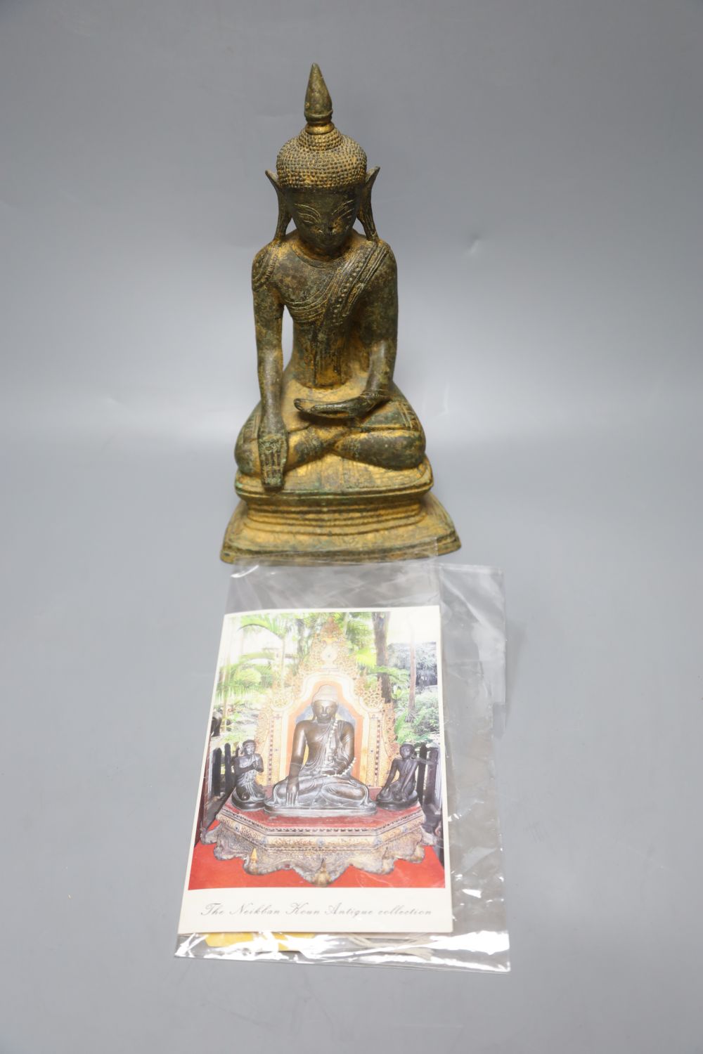 An 18th century Burmese Buddha, with traces of original gilding on bronze, height 27cm